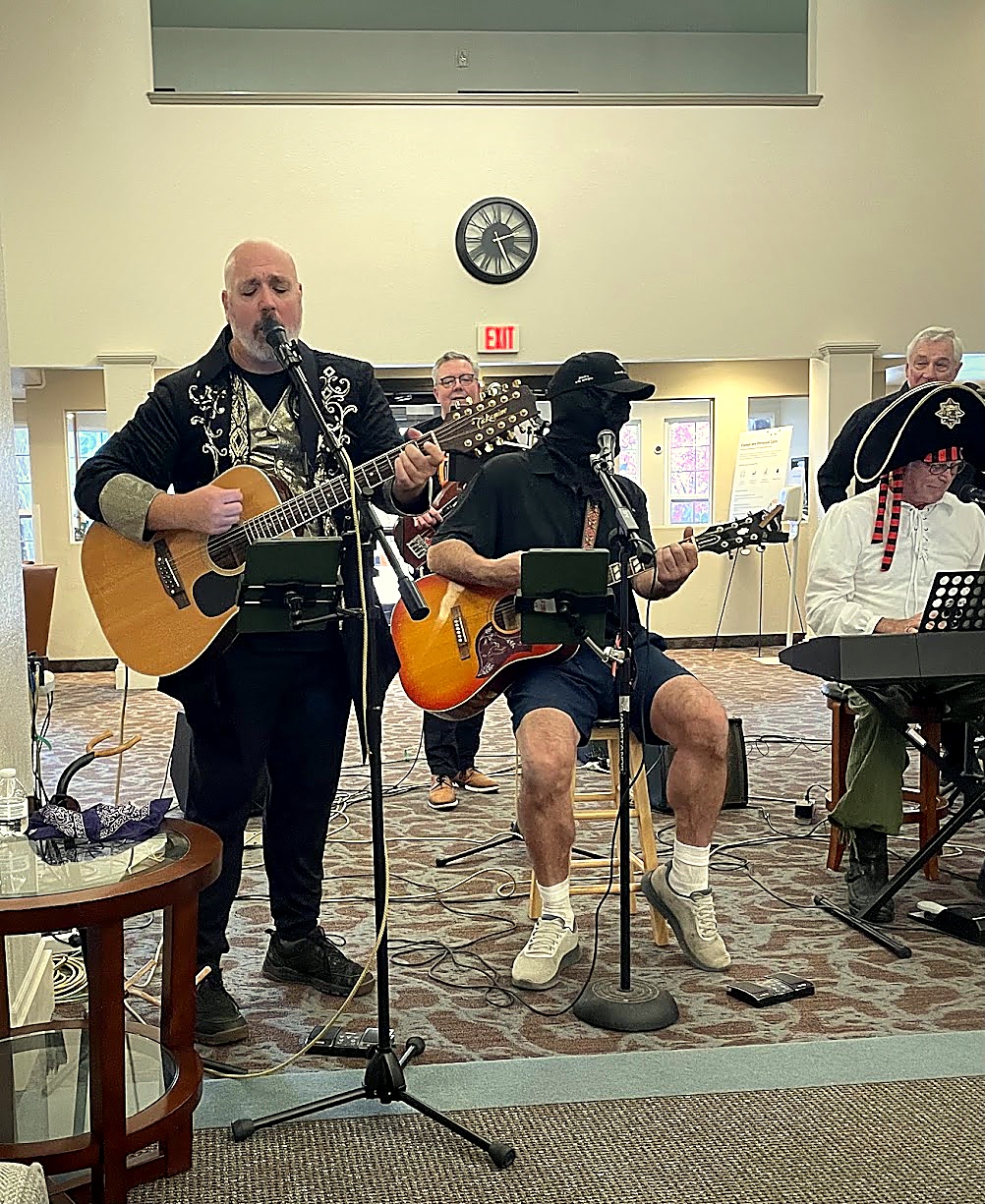 Brian, Rob, Mike, and Dave performing vocal harmonies during the live set
